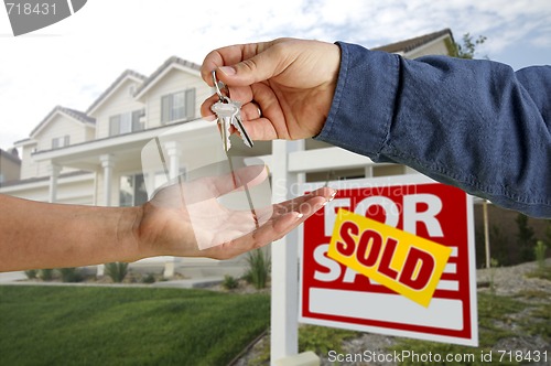 Image of Handing Over the House Keys in Front of New Home