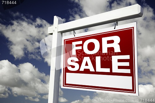 Image of For Sale Real Estate Sign on Cloudy Sky