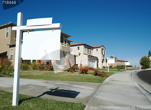 Image of Blank Real Estate Sign & New Home