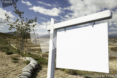 Image of Blank Real Estate Sign and Empty Construction Lots