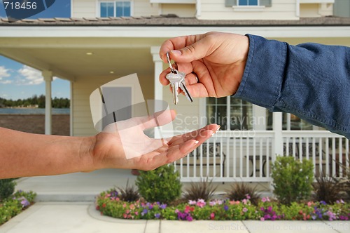 Image of Handing Over the House Keys in Front of New Home