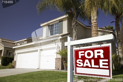 Image of Red For Sale Real Estate Sign and House