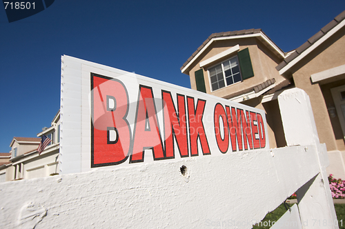 Image of Bank Owned Real Estate Sign and House with American Flag