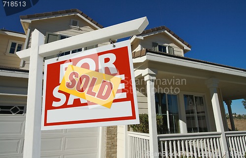 Image of Sold Home For Sale Sign in Front of New House 