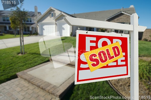 Image of Sold Home For Sale Sign and House