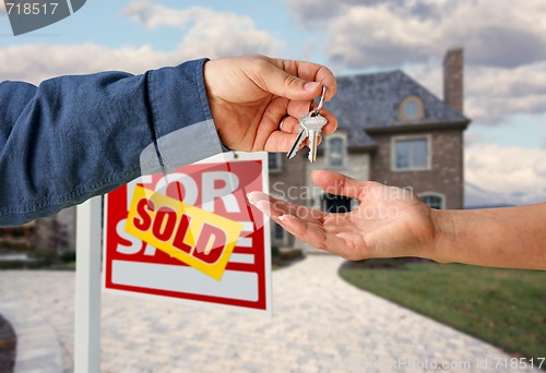 Image of Handing Over the House Keys in Front of New Home