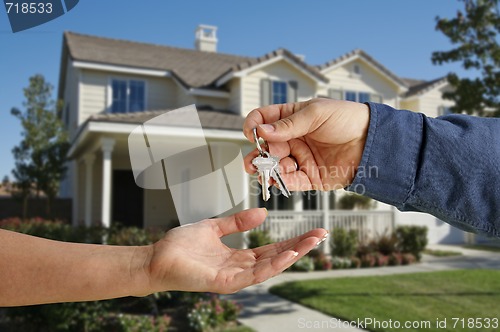 Image of Handing Over the House Keys in Front of New Home