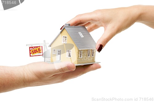 Image of Reaching For A Home with Sold Real Estate Sign