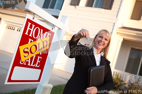 Image of Female Real Estate Agent Handing Over the House Keys