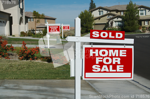 Image of Sold Home For Sale Sign & New House