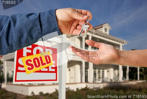 Image of Handing Over the House Keys in Front of New Home