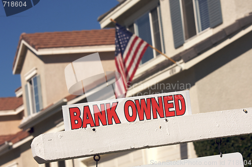 Image of Bank Owned Real Estate Sign and House with American Flag