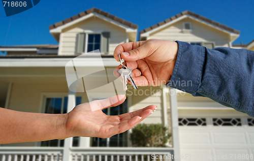 Image of Handing Over the House Keys in Front of New Home
