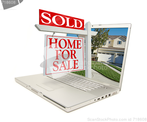 Image of Sold Home for Sale Sign & New Home on Laptop