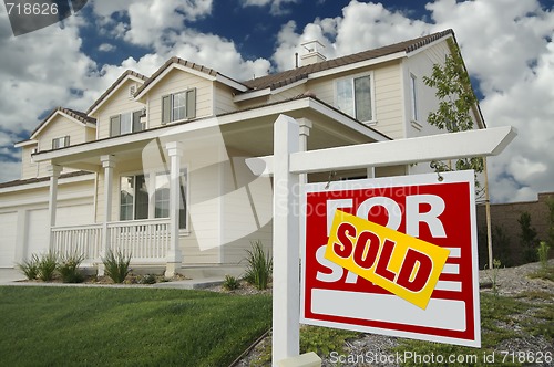 Image of Sold Home For Sale Sign and House