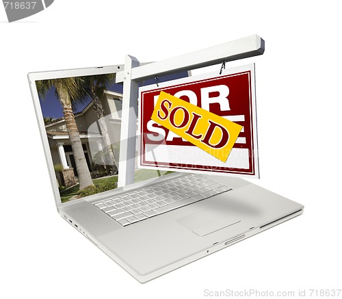 Image of Sold Home for Sale Sign & New House Laptop