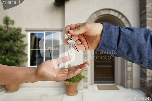 Image of Handing Over the House Keys in Front of New Home