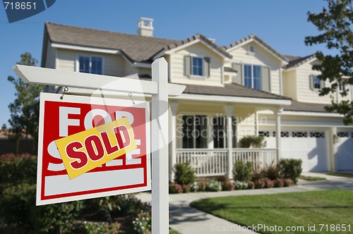 Image of Sold Home For Sale Sign and House