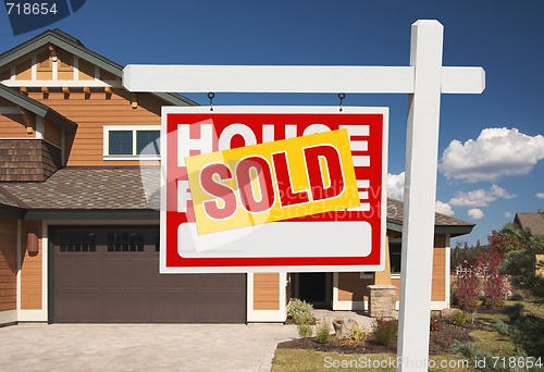 Image of Sold Home For Sale Sign in Front of New House 