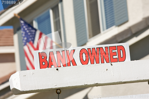 Image of Bank Owned Real Estate Sign and House with American Flag