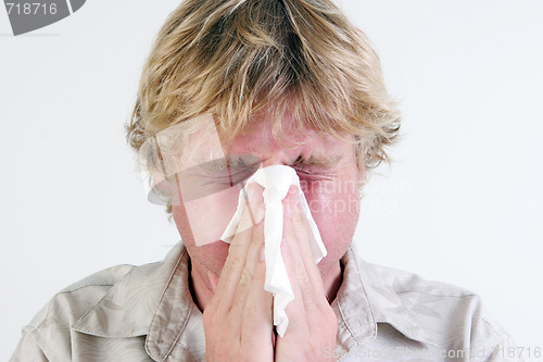 Image of Man sneezing.