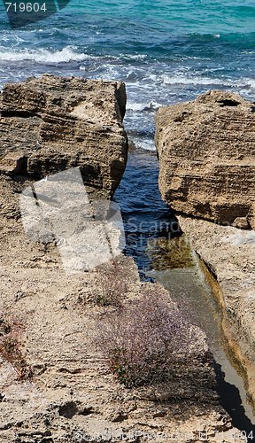 Image of Narrow crack in the rocks at sea coast in bright summer day