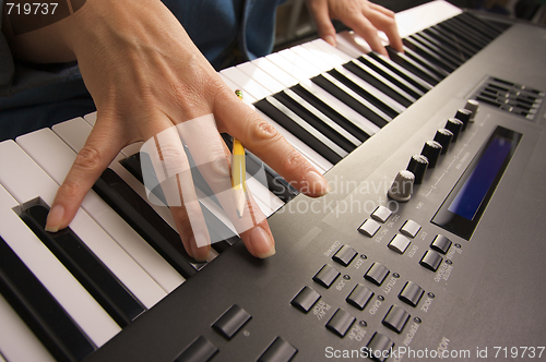 Image of Woman's Fingers on Digital Piano Keys