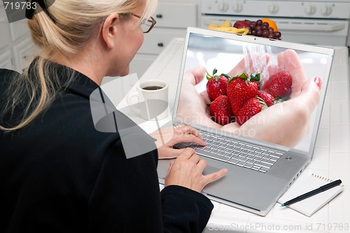 Image of Woman In Kitchen Using Laptop - Food and Recipes