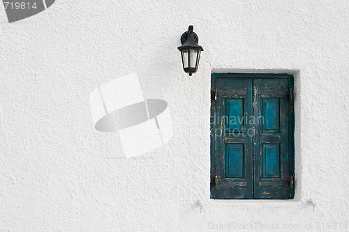 Image of Abstract close-up of Santorini home wall, window and lamp.