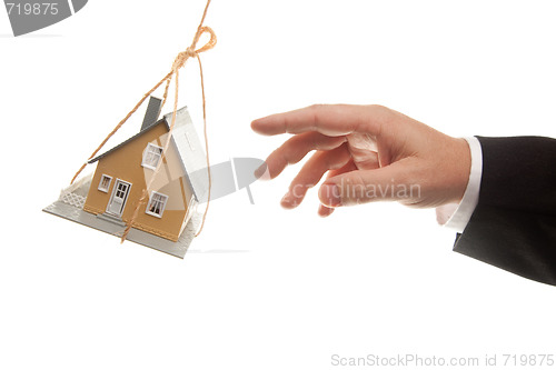 Image of Swinging House and Business Man's Hand Reaching or Pushing