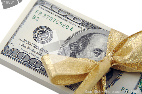 Image of One Hundred Dollar Bills Wrapped in Gold Ribbon.