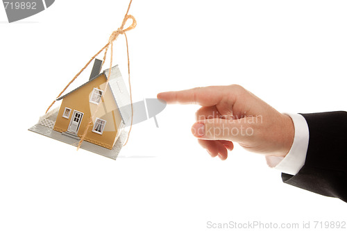 Image of Swinging House and Business Man's Hand Reaching 