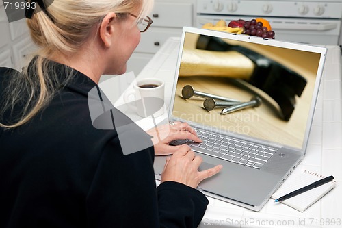 Image of Woman In Kitchen Using Laptop - Home Improvement