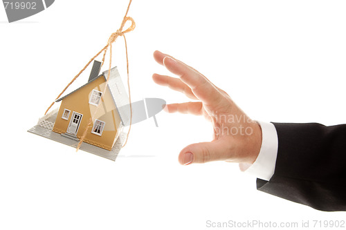Image of Swinging House and Business Man's Hand Reaching or Pushing
