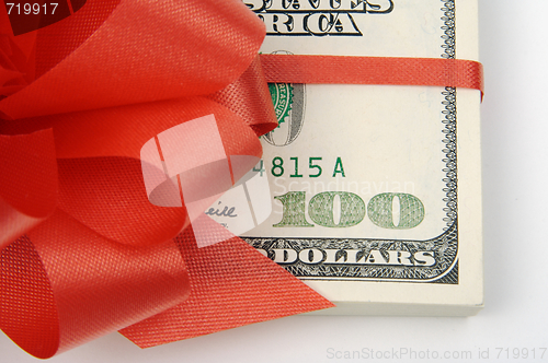 Image of One Hundred Dollar Bills Wrapped in Red Ribbon.