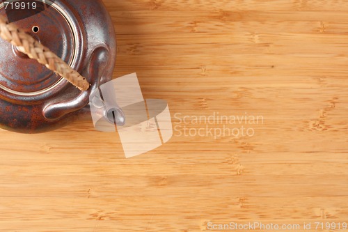 Image of Tea Pot and Bamboo Textured Surface