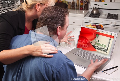 Image of Couple In Kitchen Using Laptop - Money