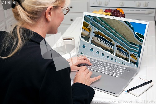 Image of Woman In Kitchen Using Laptop- Cruise vacation