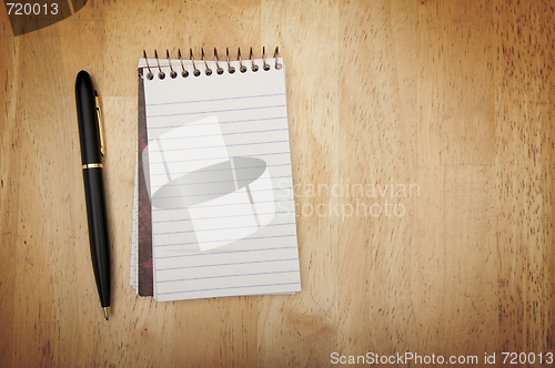 Image of Note Pad and Pen on Wood