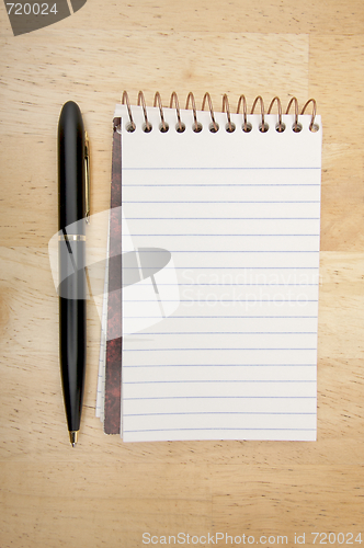 Image of Note Pad and Pen on Wood