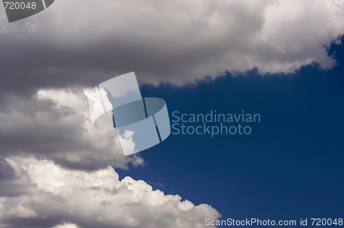 Image of Puffy Clouds on a blue sky.