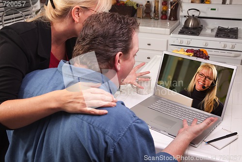 Image of Couple In Kitchen Using Laptop - Customer Support