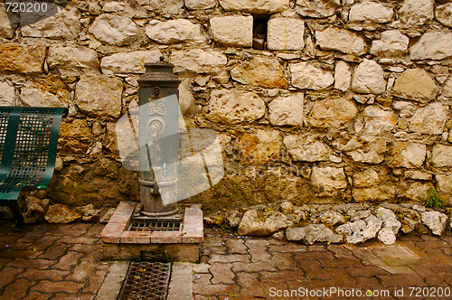 Image of Ancient Brick Wall and Water Pump