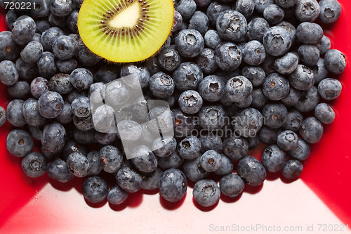 Image of Macro Kiwi and Blueberries on Red Dish