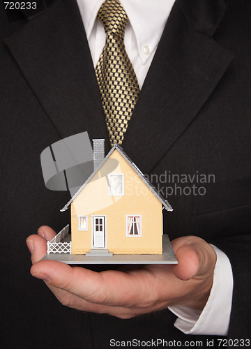 Image of Businessman Holding House
