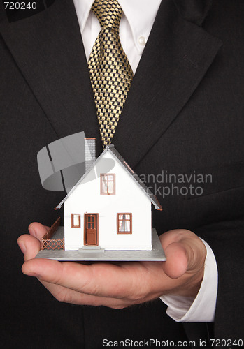 Image of Businessman Holding House
