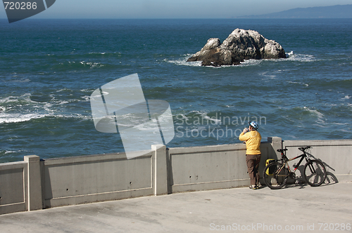 Image of Bicyclist Rests Near Ocean