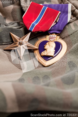 Image of Bronze and Purple Heart Medals on Camouflage Material