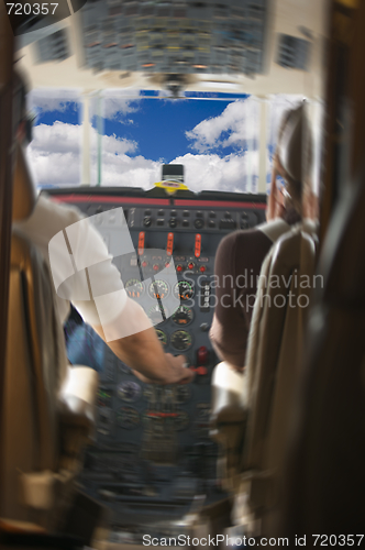 Image of Jet Cockpit with Pilots and Clouds