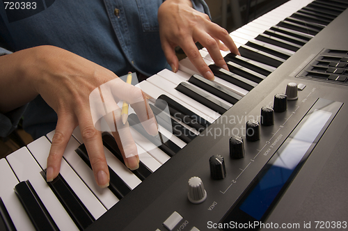 Image of Woman's Fingers on Digital Piano Keys